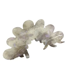 Elegant wavy acetic acid hair claw clip with pearlescent purple luster on white background