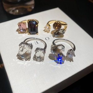 Detail showing assorted geometric open rings with sparkling colorful zircon stones