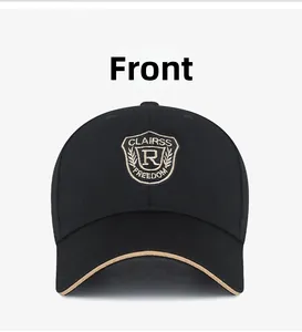 Close-up of black cotton baseball cap with shield embroidery and gold sandwich brim detail