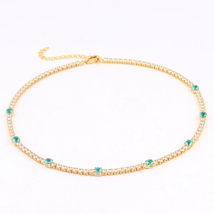 Close-up of gold tennis necklace with white zircons and turquoise stones in a full view