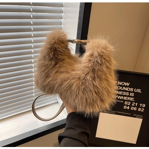 Close-up of light brown plush handbag with soft fur texture and leather strap details