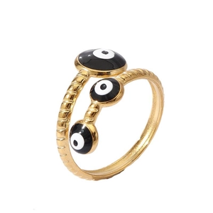 Detailed close-up of 18k gold evil eye ring with enamel eyes and twisted texture