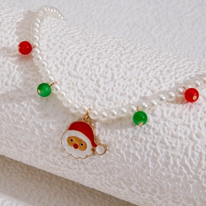 Detailed view of Christmas pearl necklace with Santa Claus pendant and festive beads