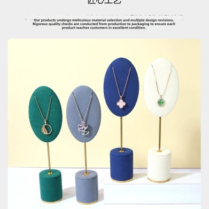 Detailed macro view of four velvet necklace stands in green, gray, blue and white colors