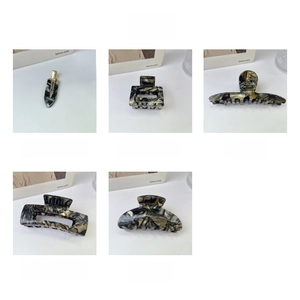 Detailed collection of black and gold acetate hair claws with premium tortoiseshell patterns