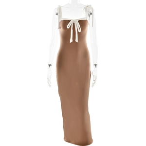 Detail view of the brown dress with white bow tie and slim fit bodycon silhouette