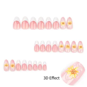 Pink French tips press on nails with 3D yellow floral patterns and pearl decorations