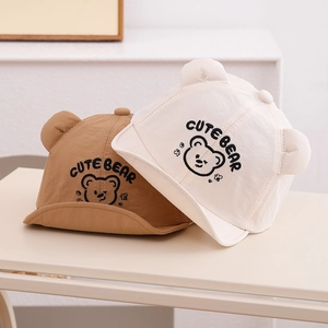 Detailed embroidery of cute bear faces on khaki and off-white baby sun hats