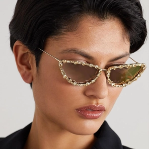 Luxury cat-eye sunglasses with gold metal frame and sparkling crystal embellishments