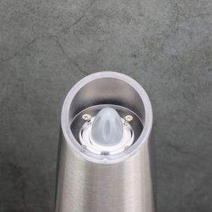 Close-up of the adjustable top knob for coarseness on a brushed metal pepper grinder