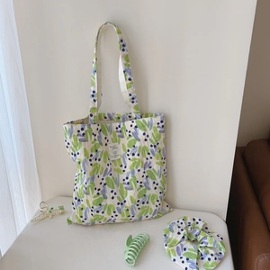 Detail of floral printed cotton tote bag with matching scrunchie and hair clips