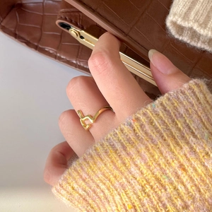 Close-up of minimalist gold plated geometric ring with asymmetric polished finish