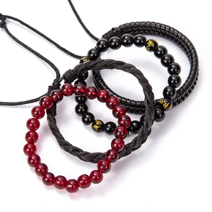 Detailed macro view of four-piece retro multilayer braided leather and bead bracelet set