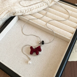 Detailed view of red flocked horse pendant with zircon accents and pearl drop