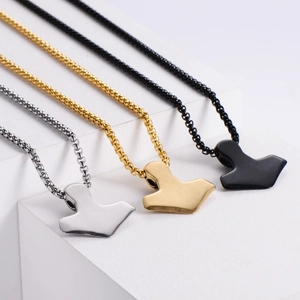 Detailed view of three Mjölnir necklaces in silver, gold, and black finishes