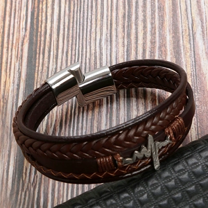 Detail of dark brown braided leather bracelet with heartbeat charm and magnetic clasp