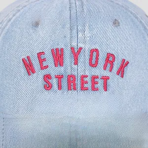 Detailed close-up of 3D New York Street embroidery on light blue denim baseball cap