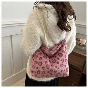 Detail view of pink leopard heart pattern on soft plush tote bag with furry texture