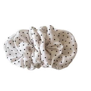 Elegant white pleated cloud banana hair clip with black polka dots on white background