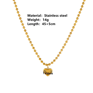 Gold stainless steel beaded chain necklace featuring a polished heart pendant on white background