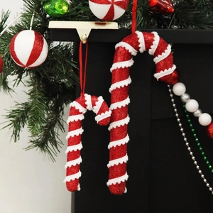 Red and white foam candy cane Christmas tree ornaments with sequins and pine branch decor