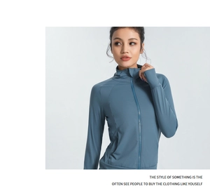 Detail of slim fit yoga jacket featuring high-neck zipper and functional thumbhole cuffs