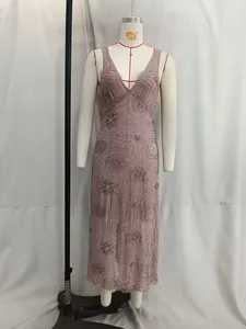 Close-up of sequined floral embroidery and deep V-neck on this elegant midi dress