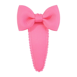 Detail of bright pink grosgrain ribbon bow hair clip with fully fabric covered BB snap base