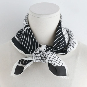 Detail of a 70cm silk-like scarf with black and white geometric patterns on a mannequin