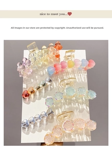 Close-up of cute heart and rose acrylic hair claw clips in various pastel colors
