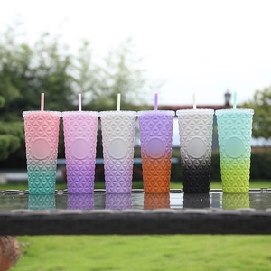 Detail of gradient studded tumblers with textured geometric pattern and straws