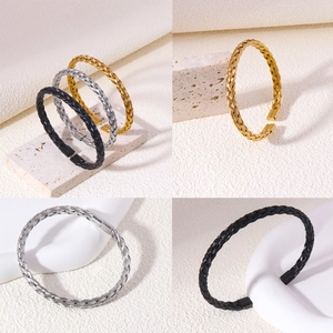 Close-up of twisted texture and metallic finish on handmade stainless steel cuff bracelets