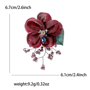 Detail view of burgundy lace flower brooch with crystal beads showing size specifications