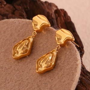 Detailed view of irregular 18K gold plated earrings with vintage lava metal texture