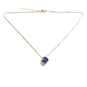 Detailed shot of the gold-plated cylinder necklace with blue enamel and red heart