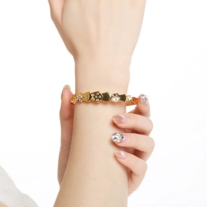 Detailed view of 18K gold plated geometric scale bracelet with clear round rhinestones