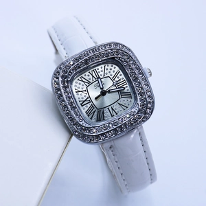 Detail of square silver watch face with Roman numerals and diamond-encrusted bezel