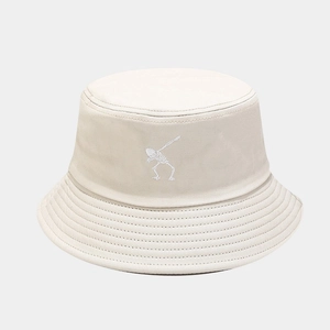 Close-up detail of white skeleton embroidery on a beige cotton punk style bucket hat