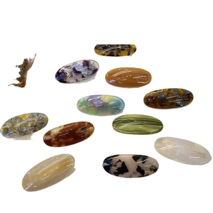 Handmade acetate oval hair clips with tortoiseshell and marble patterns in various colors