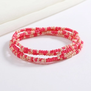 Detailed close-up of pink and white beaded elastic body chain with resin texture