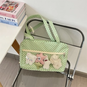 Detail of light green polka dot canvas tote with transparent PVC pocket for plush toys