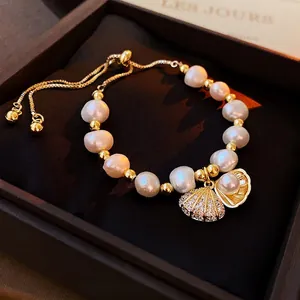 Elegant adjustable freshwater pearl bracelet with gold shell charms and zircon stones