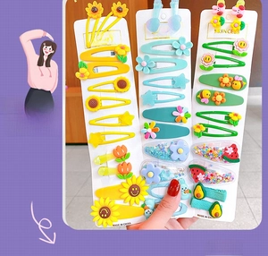 Close-up of candy-colored hair clips featuring resin sunflower and avocado designs