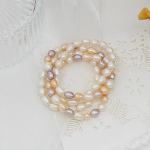 Detail of baroque freshwater pearl bracelet in white, lavender, and gold tones