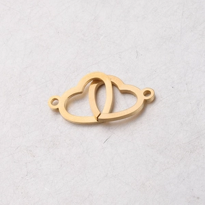 Macro view of interlocking gold stainless steel double heart connector charms for DIY jewelry