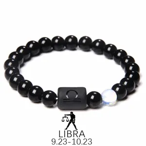 Detailed macro of Libra obsidian bracelet featuring matte zodiac bead and luminous stone