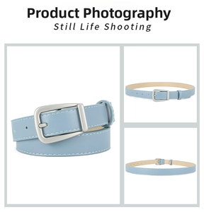 Detail of light blue PU leather belt with silver buckle and white contrast stitching
