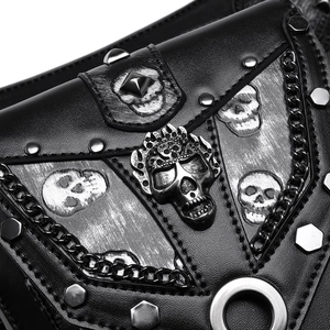 Close-up of punk crossbody bag with metal skull badge and studded leather texture