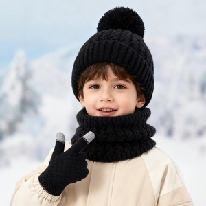 Kids winter set including black knit beanie with pom-pom, neck gaiter, and touch gloves