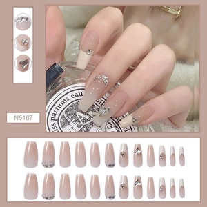 Detail of French gradient long trapezoid press-on nails with rhinestones and heart sequins
